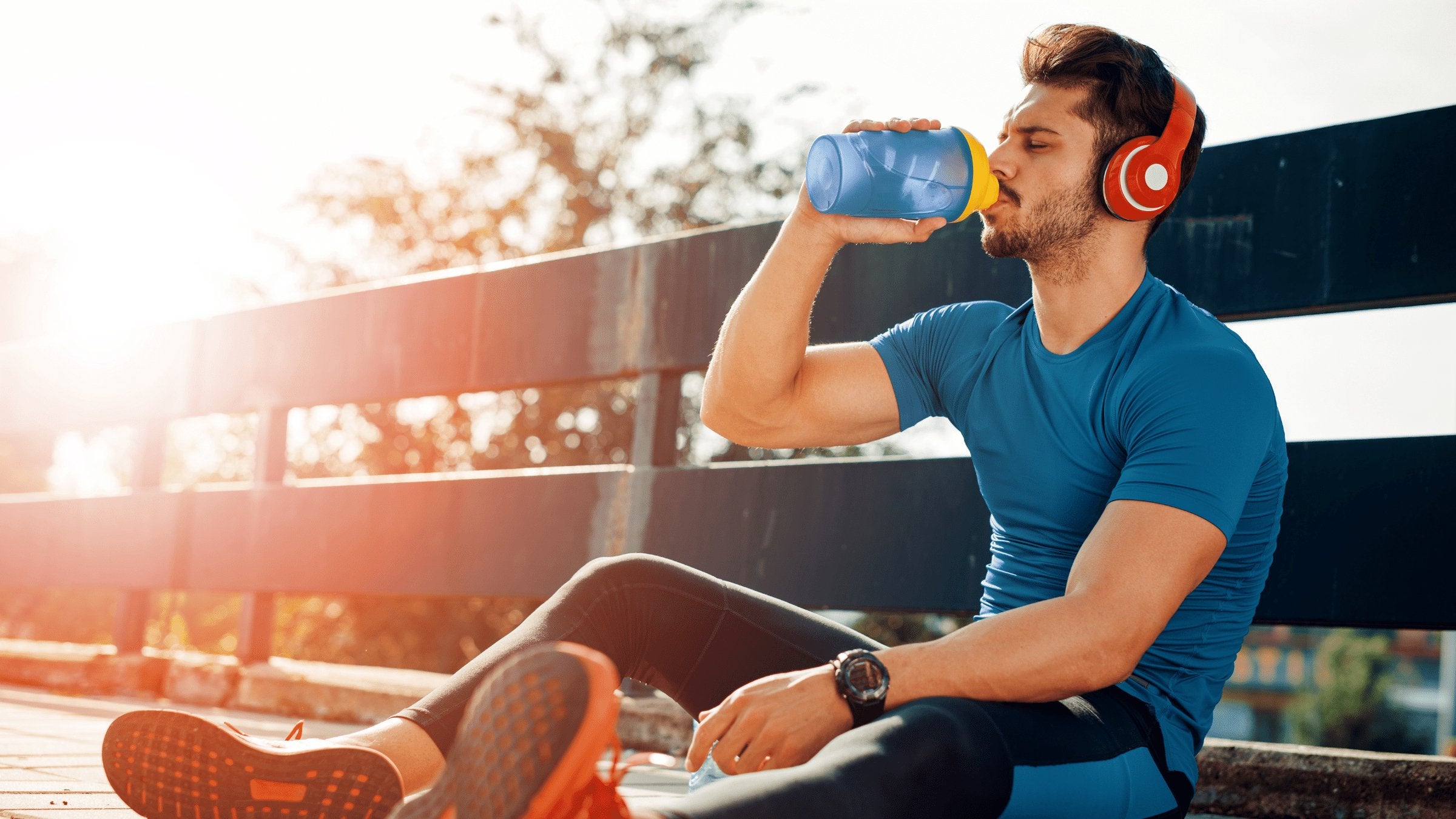 a man drinking electrolytes in a shaker